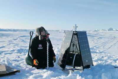 Emily Fedders with a SIDEx buoy on site in Alaska
