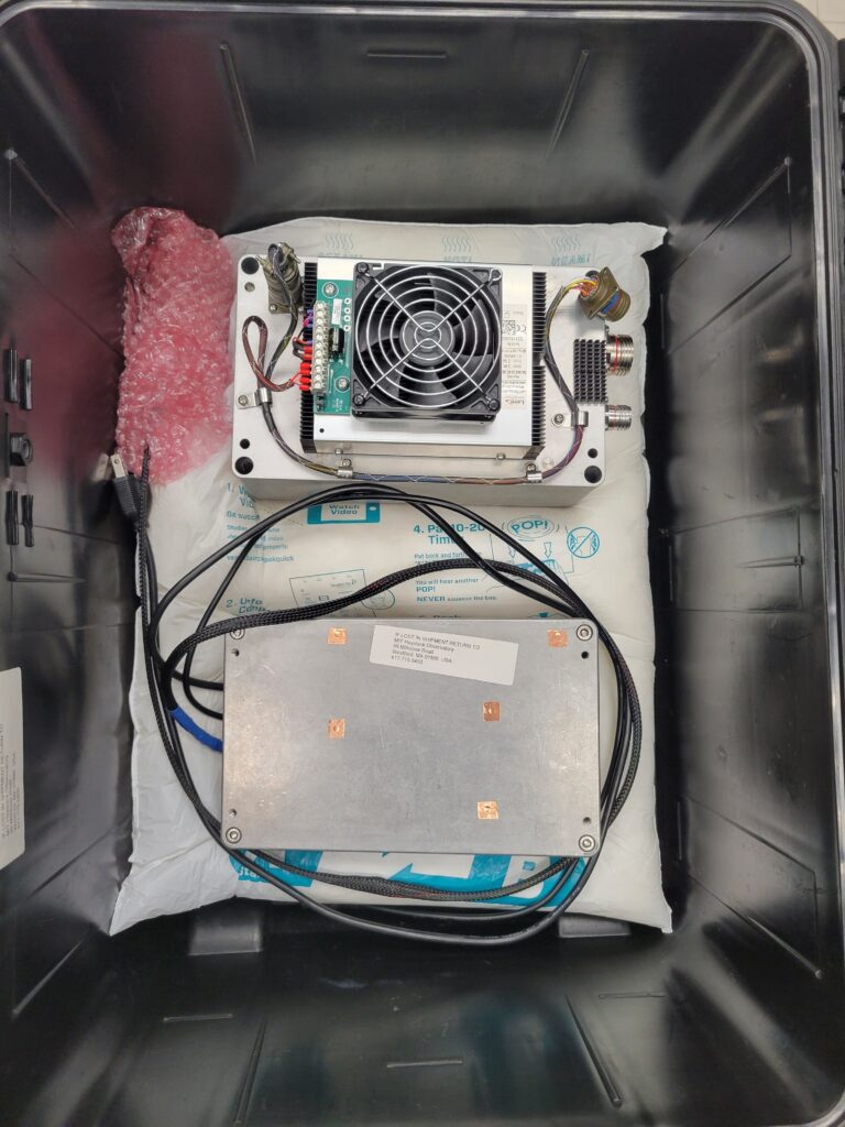 Two pieces of technology in a silver box with wires connecting them